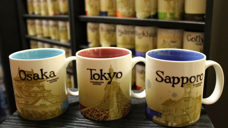 Starbucks Osaka, Tokyo, Sapporo Global Icon mugs in front of a shelf of various mugs
