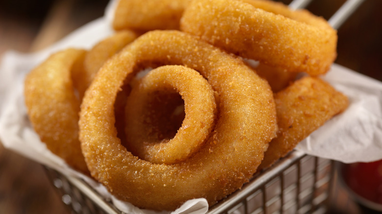 A restaurant basket of onion rings.