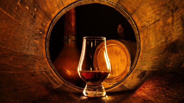 Whiskey glass in a barrel
