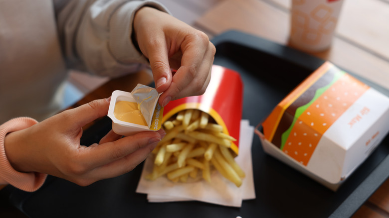 Person opening McDonald's sauce