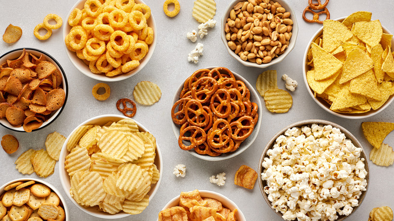 nuts, chips, and other party snacks laid out on a table