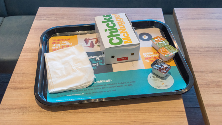 A McDonald's tray with an order of Chicken McNuggets and dipping sauces