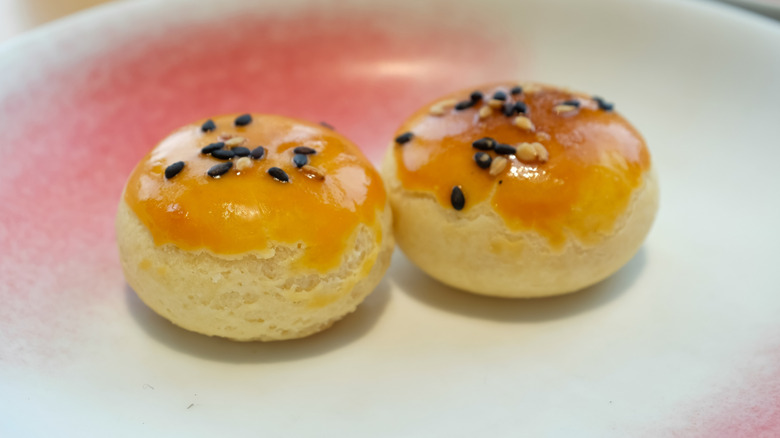 Two char siu pork puffs on a plate