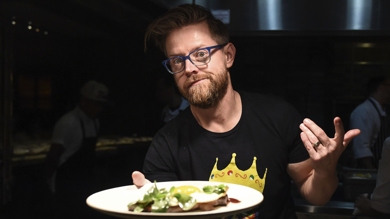 Chef Richard Blais holding a plate of food