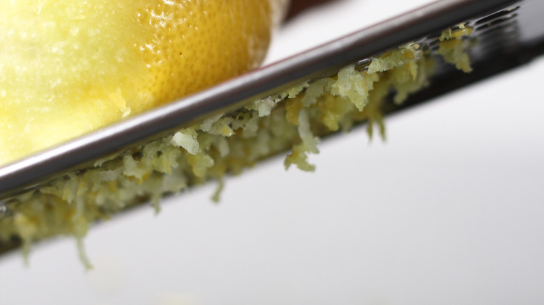 Lemon being zested with a microplane