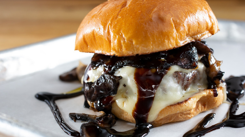 A mushroom and balsamic cheeseburger on a plate