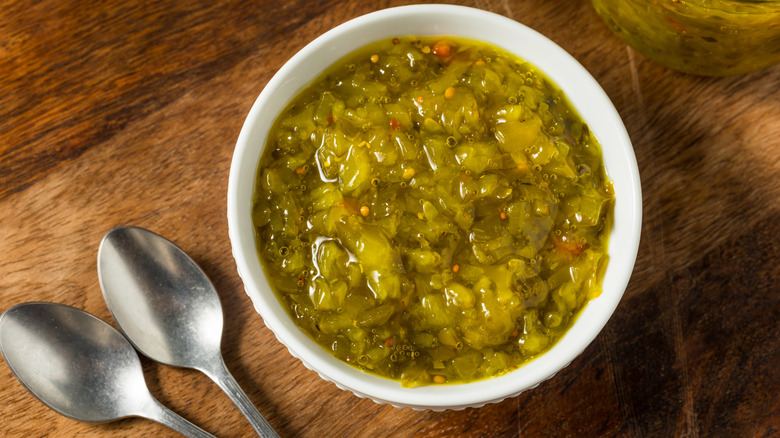 bowl of sweet pickle relish on a wooden cutting board