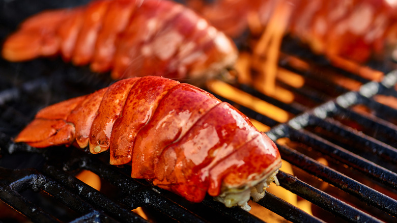 Lobster tails cooking on the grill.