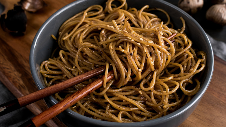 bowl of garlic noodles with chopsticks