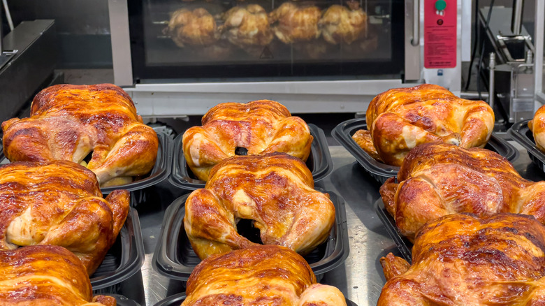 Batches of rotisserie chicken at a grocery store all perfectly cooked