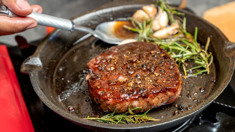 a person cooking a tenderloin steak