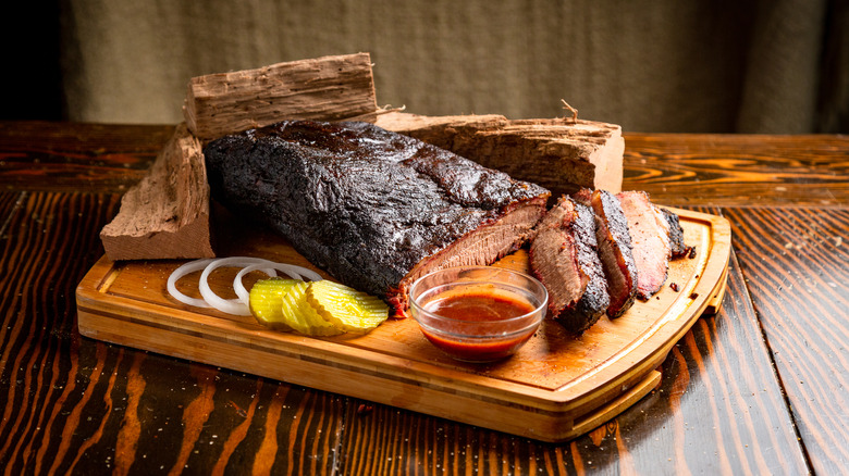Barbecue and pickles on a wooden platter