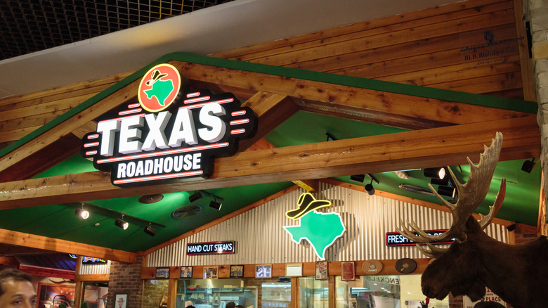 A Texas Roadhouse location, characterized by its wood accents and moose head mounted on the wall.