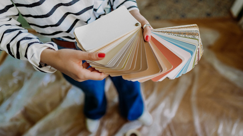 Person holding paint color samples