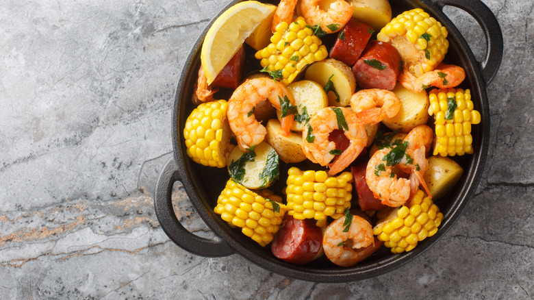 Cast iron pot full of seafood boil ingredients