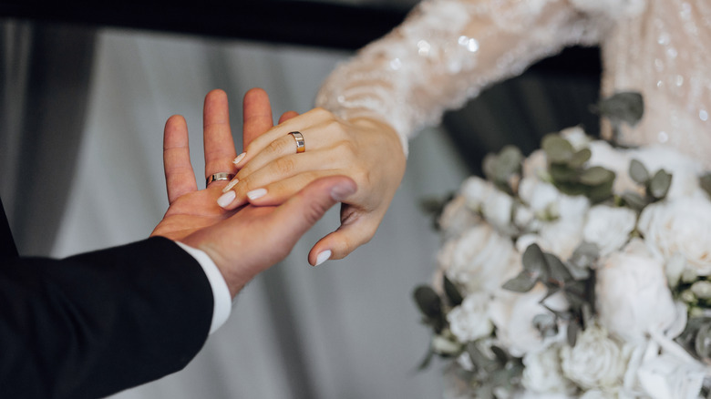 Bride and groom holding hands