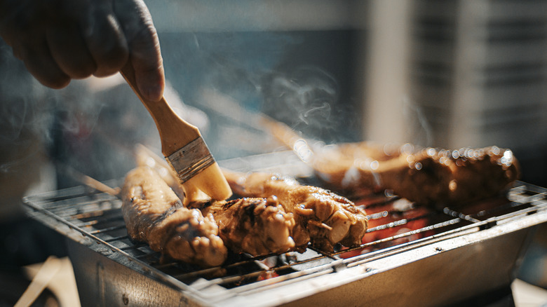 Marinade brushed onto grilling chicken