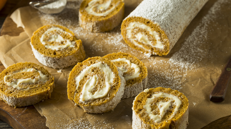 Slices of pumpkin roll on a sheet of brown wax paper