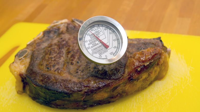 A steak with a thermometer in it