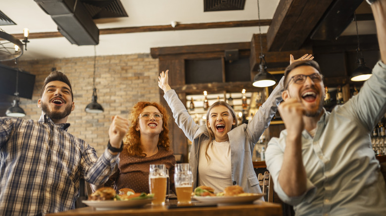 Customers cheering in a restaurant