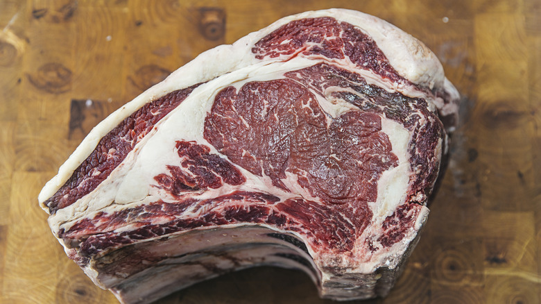 Raw prime rib on cutting board