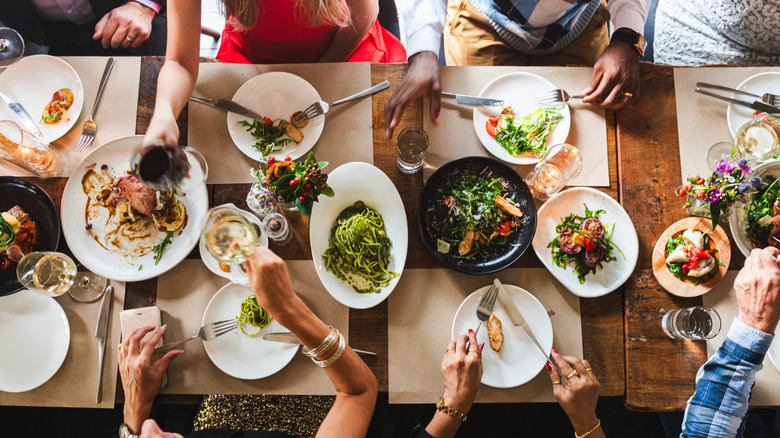 people dining out with plates and drinks on the table