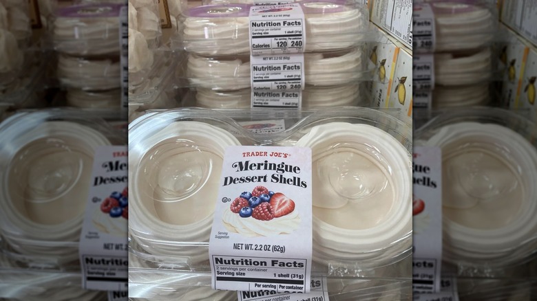 someone holding a pack of Trader Joe's Meringue Dessert Shells
