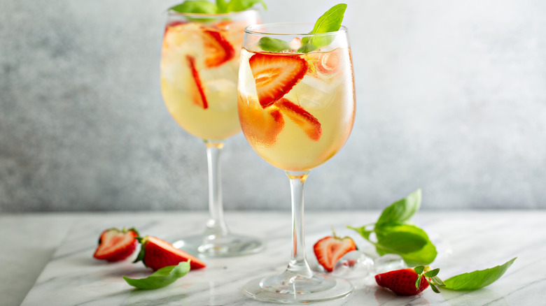 White summer sangria with strawberries in glasses