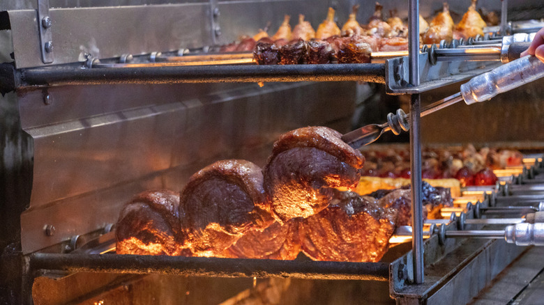 Picanha being roasted in a churrasqueria.