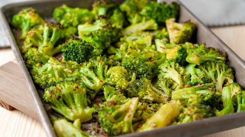 A close-up of oven-roasted broccoli on a sheet pan.
