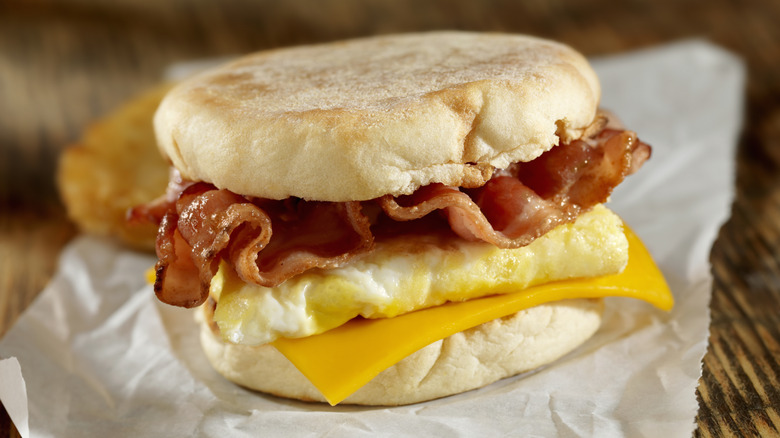 Breakfast sandwich with bacon, cheese, and a square egg