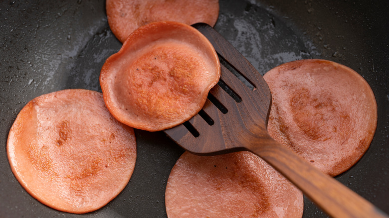 Bologna frying in a pan