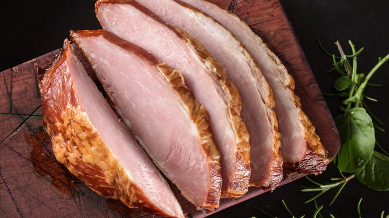 A closeup of a sliced ham.