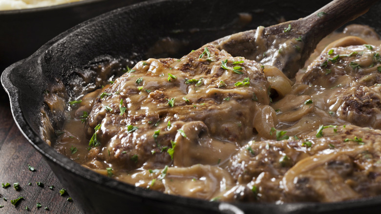 Salisbury steak and mushroom gravy in cast iron pan