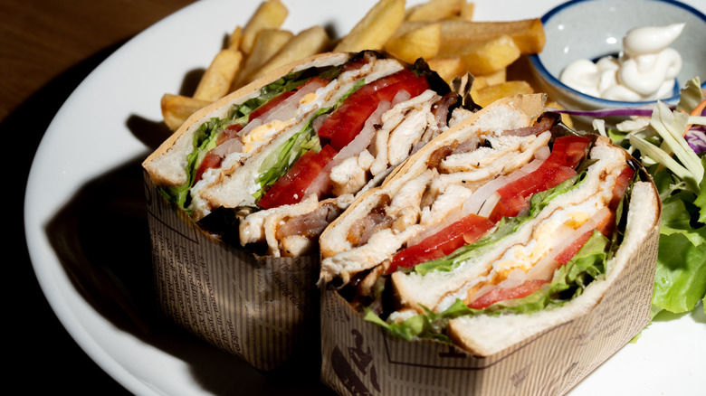 Two halves of a chicken club sandwich.