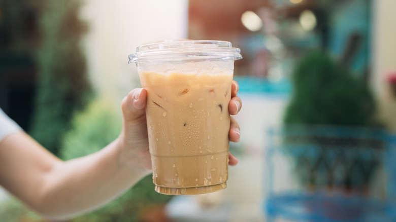 Holding iced coffee