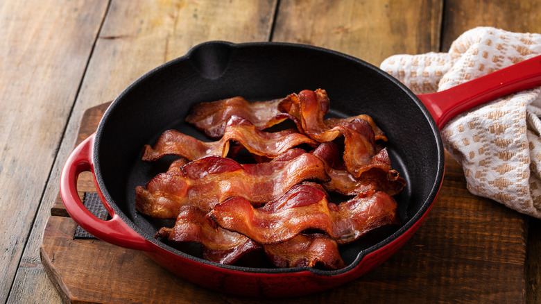 Cooked bacon in a cast iron pan.