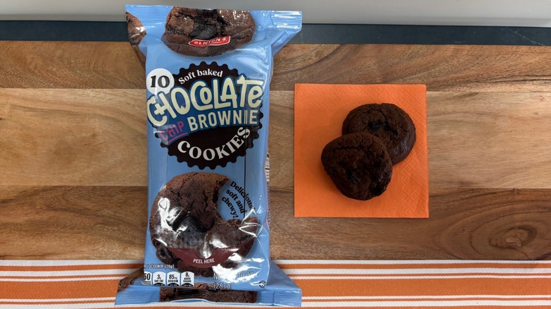 Benton's Chocolate Chip Brownie Cookie package next to two cookies on a napkin