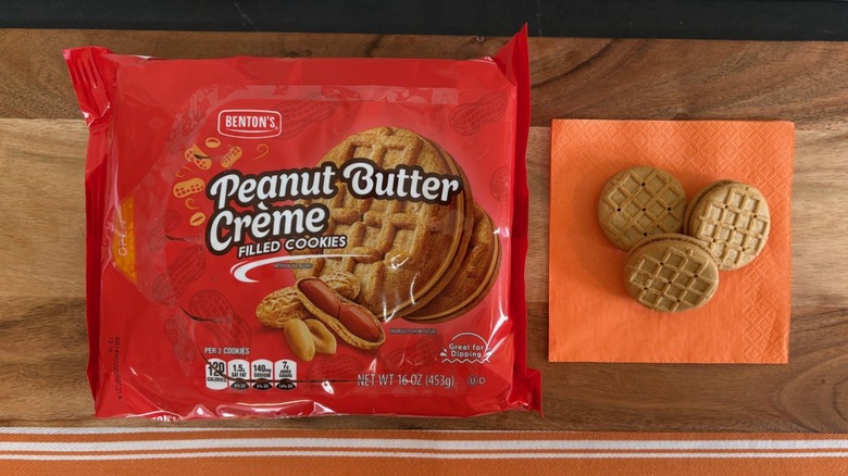 Benton's Peanut Butter Creme cookie package next to three cookies on orange napkin