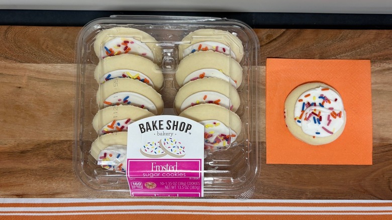Aldi Bake Shop Frosted Sugar Cookie container next to single cookie on orange napkin