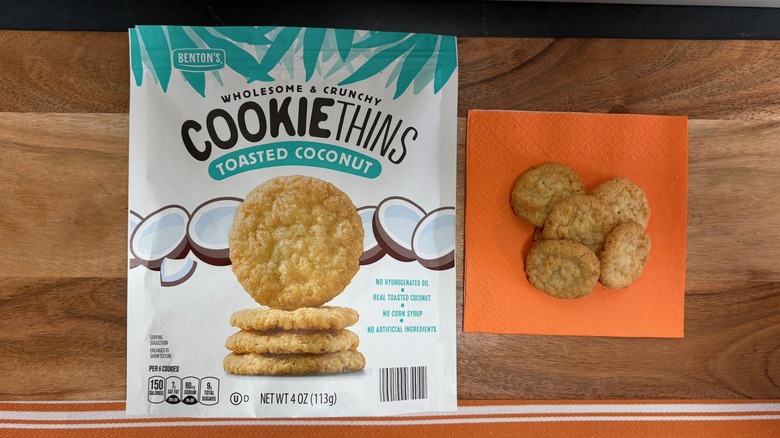 Benton's Toasted Coconut Cookie Thin package next to five cookies on orange napkin