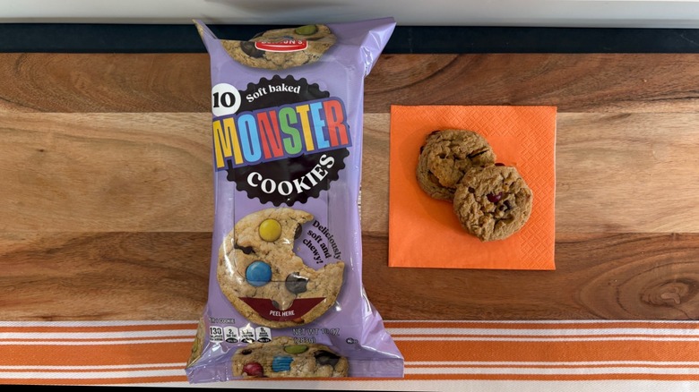 Benton's Monster Cookie package next to two cookies on orange napkin