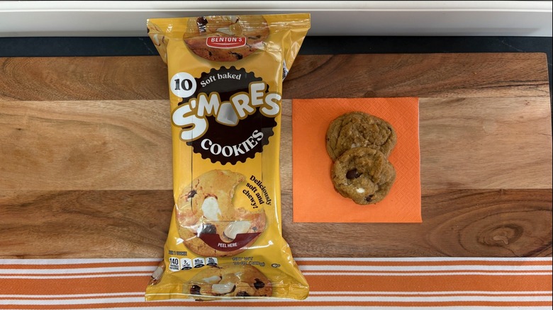 Benton's Smores Cookie package next to two cookies on orange napkin
