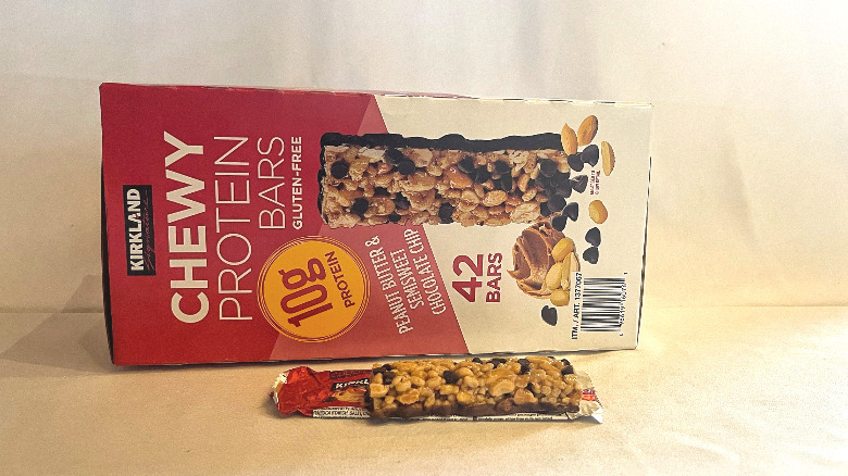 Unwrapped Chewy Protein Bar beside its packaging