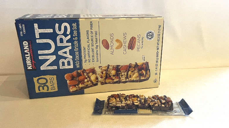 Unwrapped Nut Bar beside its packaging