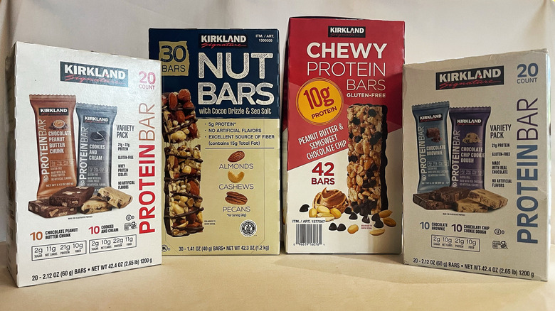 Four boxes of protein bars from Costco with a white background