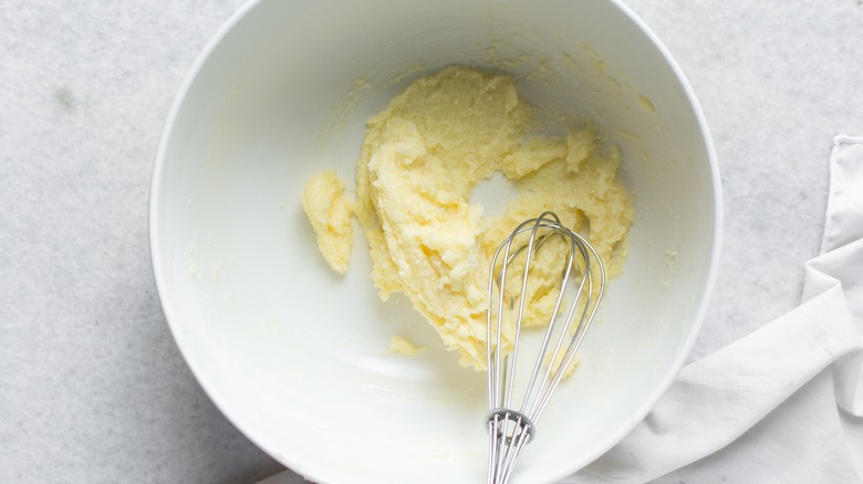mixing butter in bowl with a whisk
