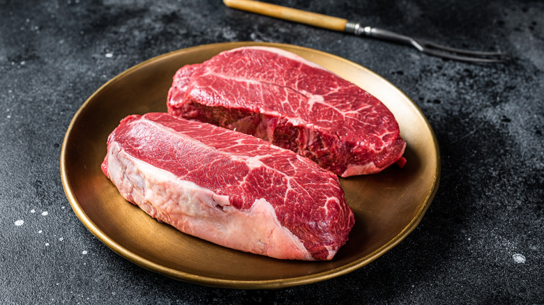 Raw oyster blade steaks on a plate