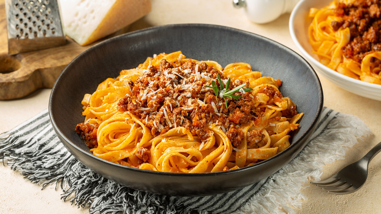 a plate of pasta with ragu sauce
