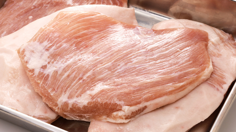 Pork jowl in a butcher tray.